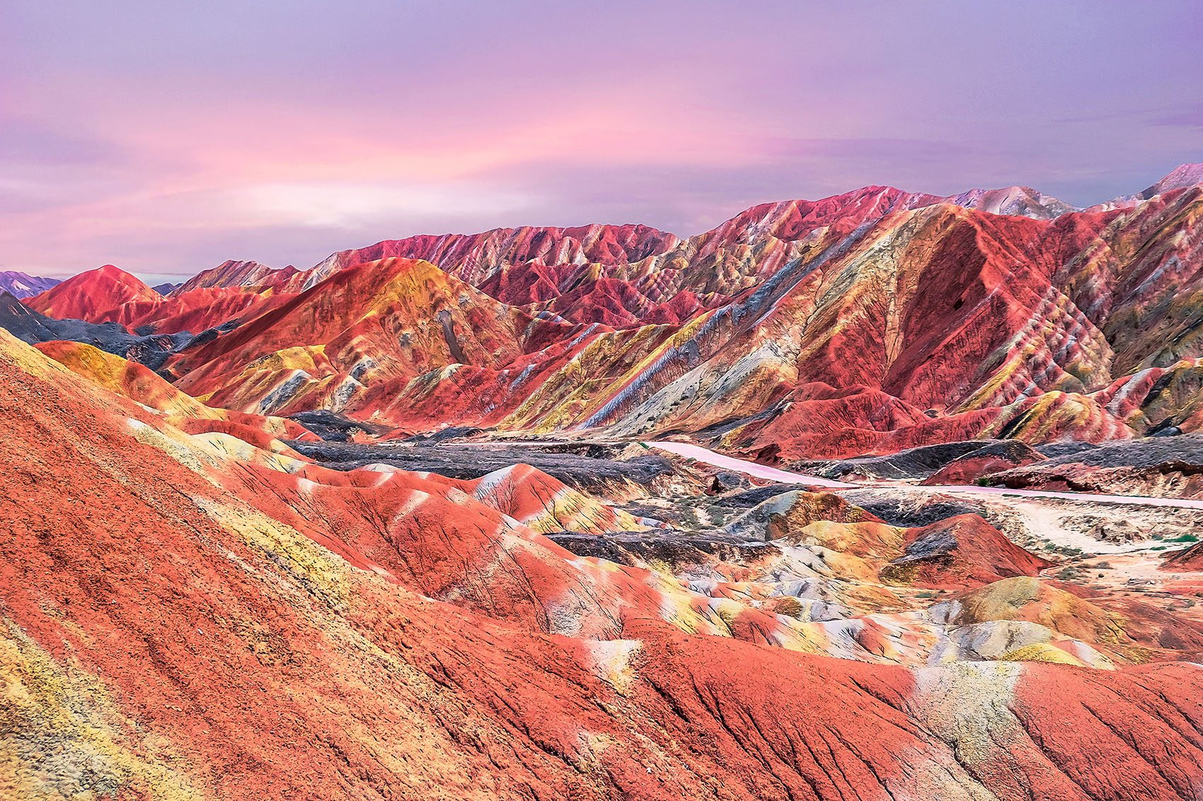 Colourful mountains against a pink sky during sunset 