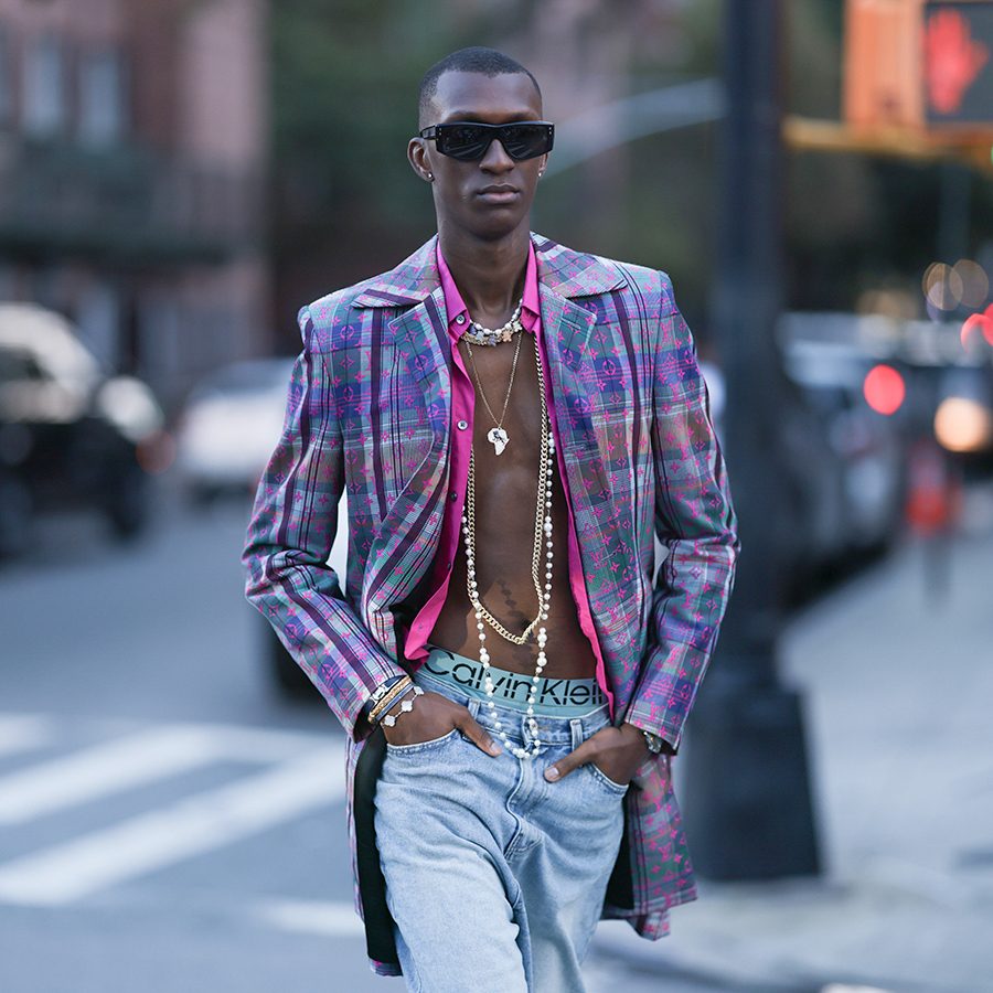 A man wearing Calvin Klein’s signature underwear, walking on the streets of New York City.