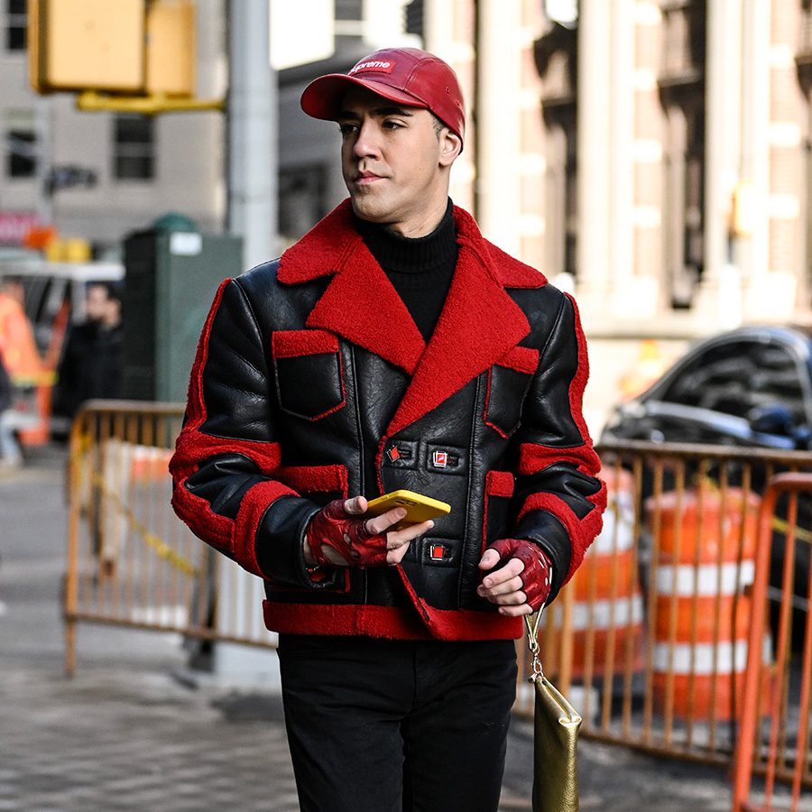 A man sporting Supreme gear on the streets of New York. 