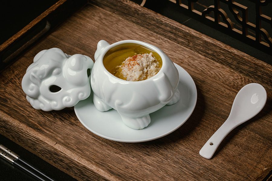 Double-boiled pork meatball with crab coral and dried shrimp roe served in a small dragon-shapped white porcelain pot, featured on the mid-autumn hairy-crab menu at Chinese restaurant Moments Together in Hong Kong 