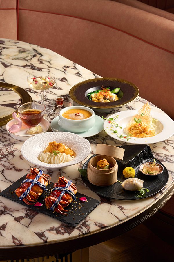 A dining table filled with various autumn dishes, a plate of steamed hairy crab with osmanthus, hairy crab, bamboo sheng and bird's nest soup, sauteed seafood and vegetables, mixed dumplings, noodles, salad, dessert, served at Voynich in Tsim Sha Tsui, Hong Kong 