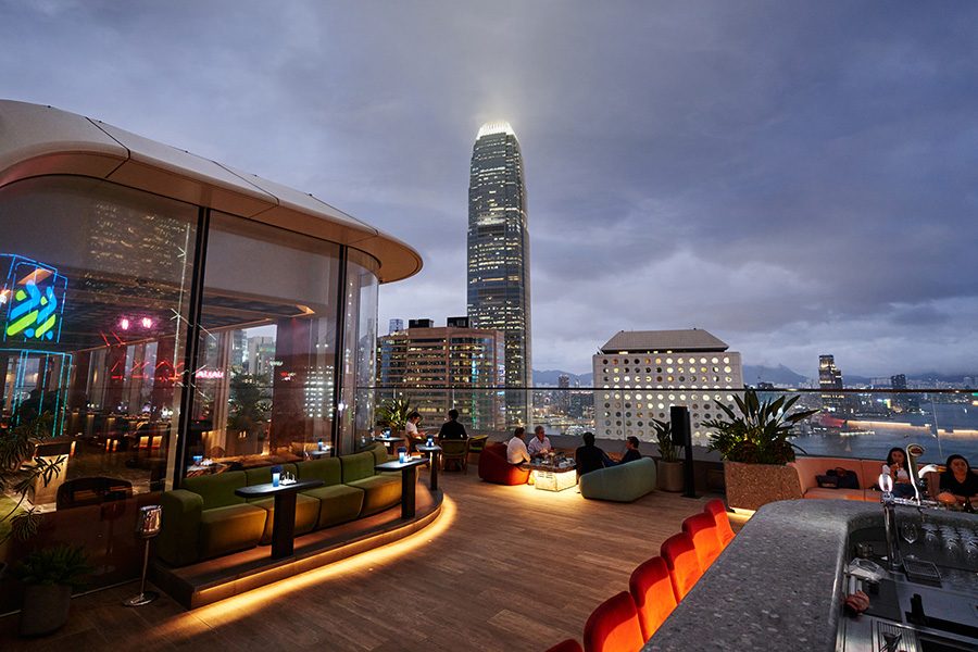 The outdoor terrace at Cardinal Point, Hong Kong, in the evening. The ifc building is in the background.