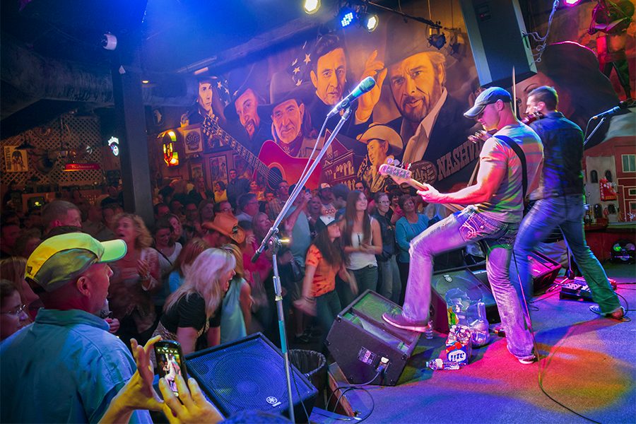 Two musicians perform on a Nashville stage.