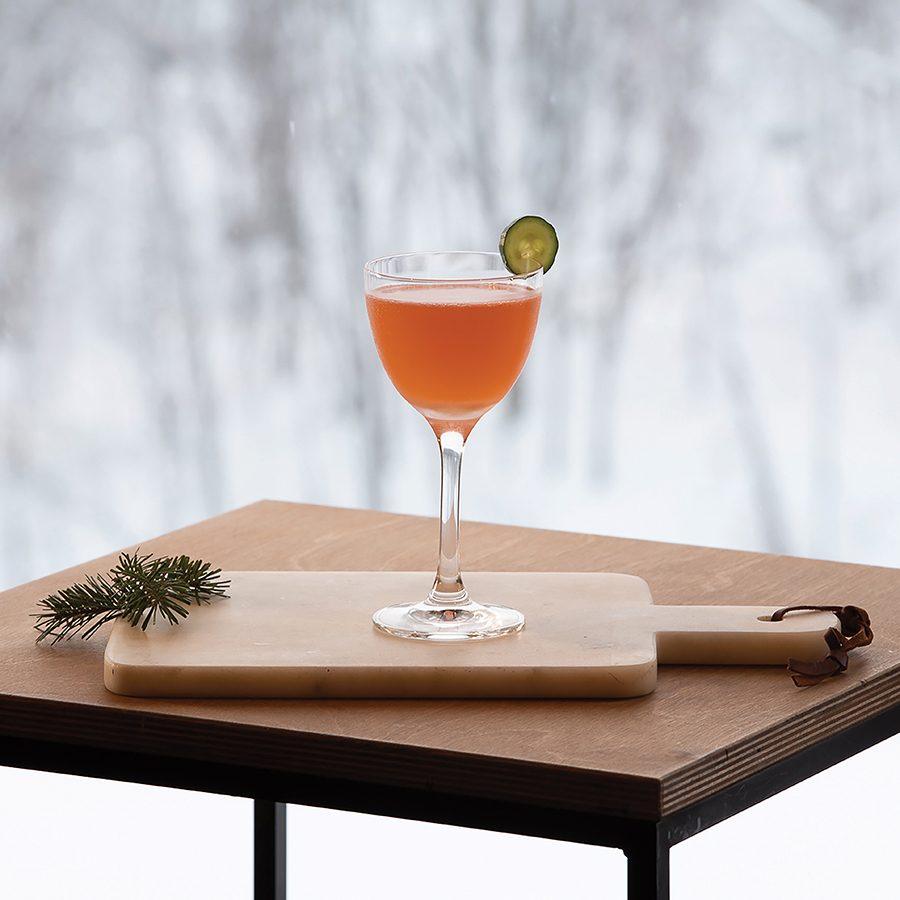 An orange whisky cocktail on a wooden board and table served at Bar Gyu in Hokkaido, Japan