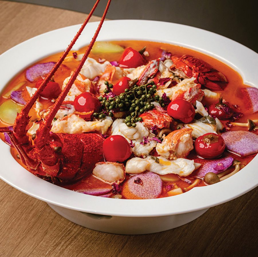A deep dish filled with lobster and fish in sour and spicy broth at Moments Together, a restaurant inside Times Square.