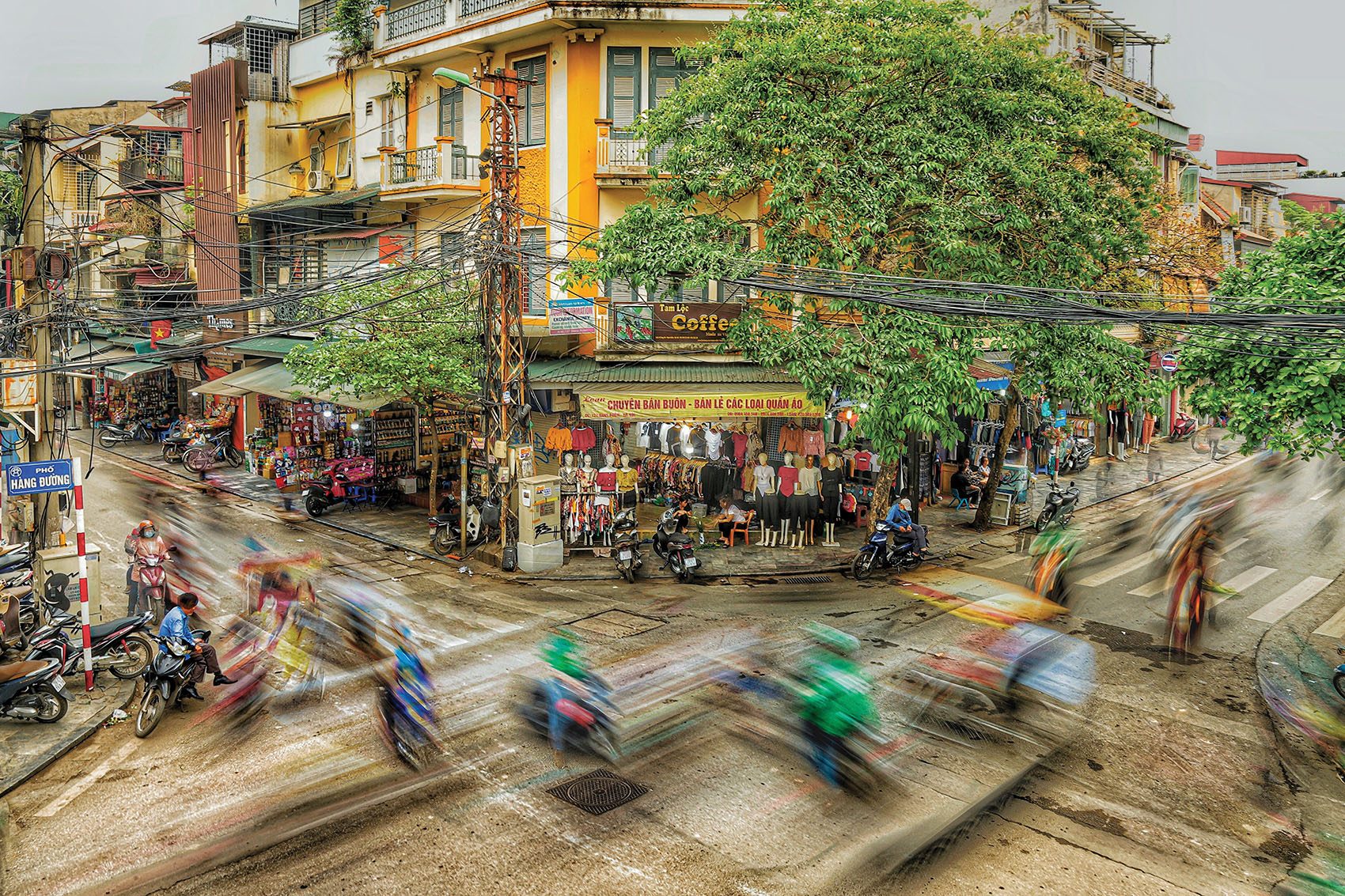 Busy traffic junction in Hanoi outside a boutique