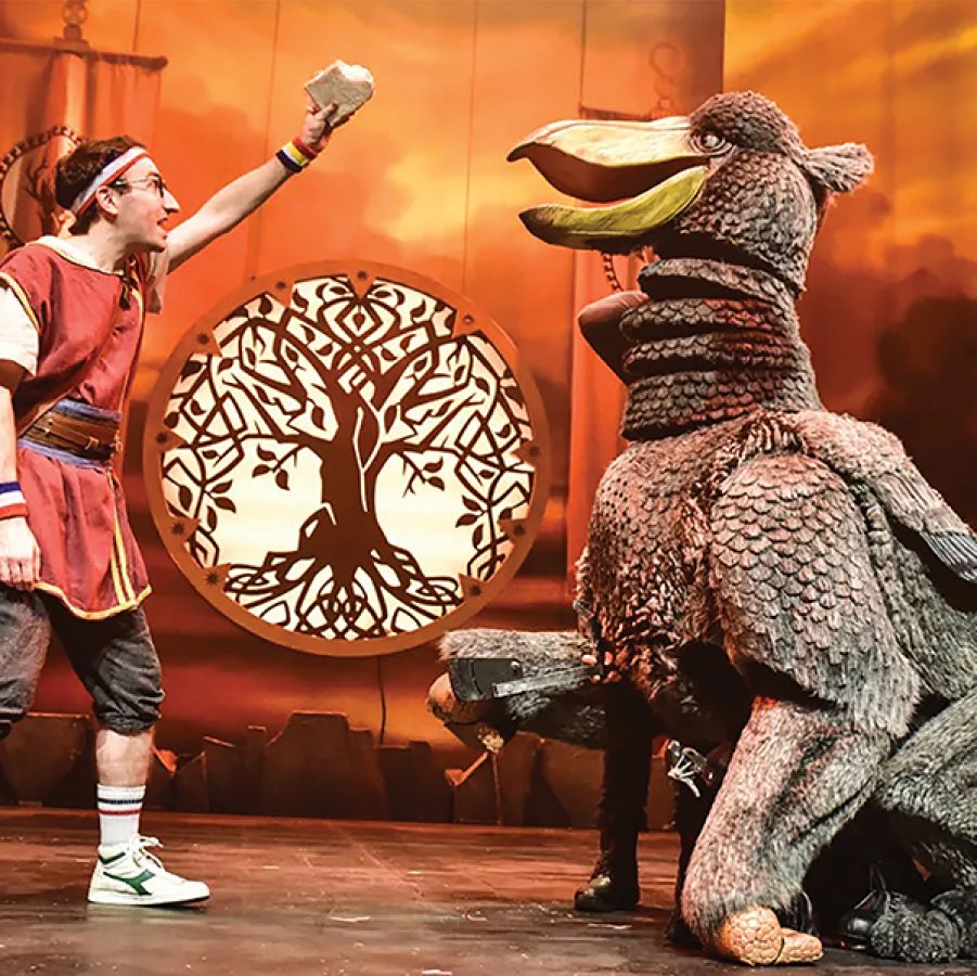 A man and a bird-like creature on stage for Dragons and Mythical Beasts.  