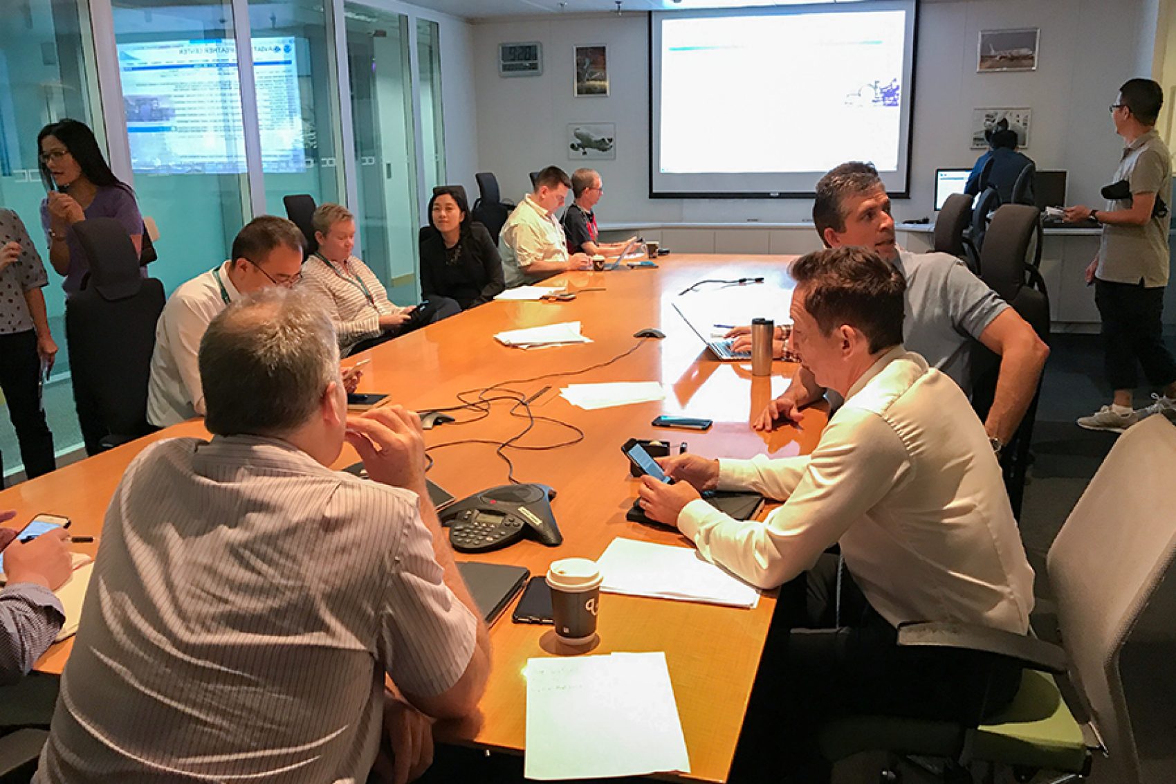 People in a boardroom having a meeting in the Integrated Operations Centre (IOC) at Cathay Pacific’s headquarters