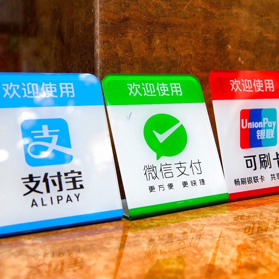 Plastic placards showing accepted modes of payment: Alipay, WeChat Pay, UnionPay and Apple Pay.