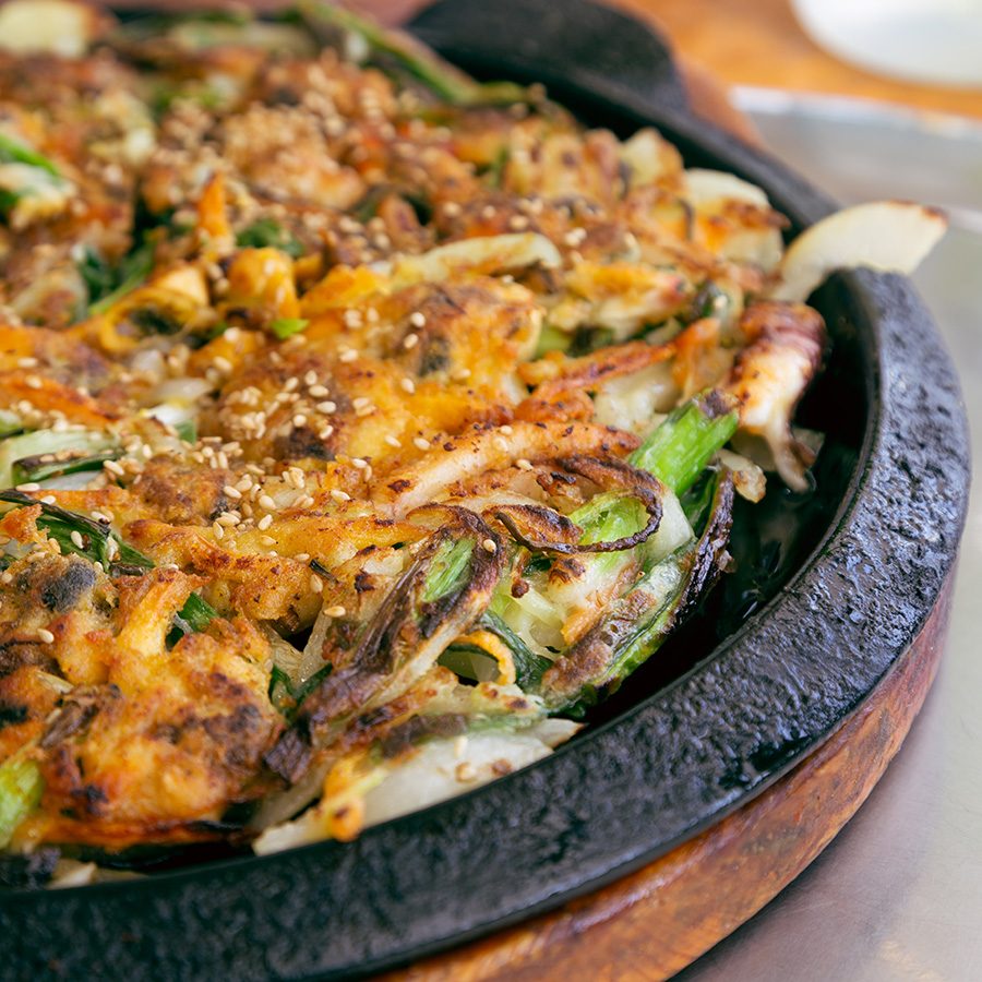A closeup of a hot plate of haemul pajeon Korean seafood pancake 