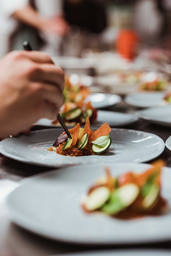 Chef plating a dish at Como The Treasury.