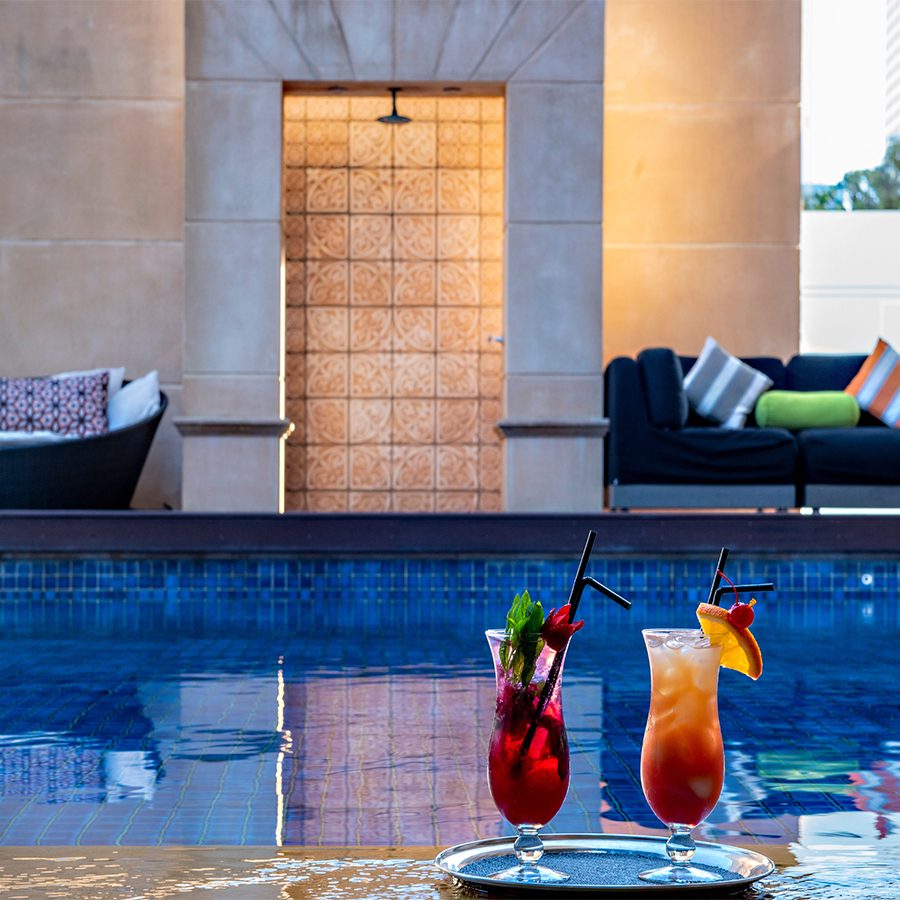 Cocktails on a table by the Duxton Hotel Perth’s swimming pool.