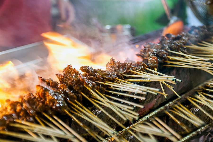 Meat skewers being cooked over live fire