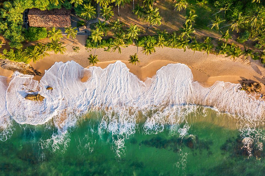 Sandy beach at high tide in Sri Lanka