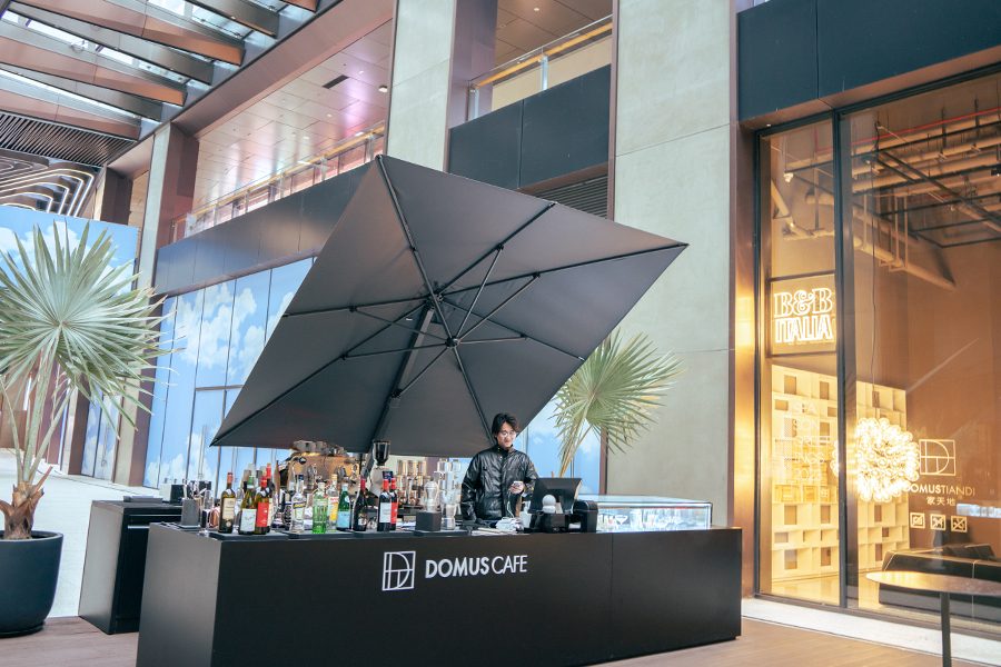 Exterior of a few shopfronts and an outdoor bar in Upperhills.