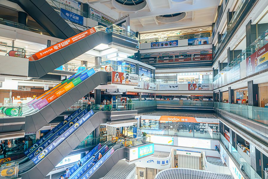 The multiple floors of Huaqiang Electronic World, lit up brightly by signs. 