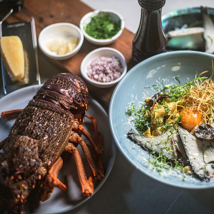 Grilled seafood and salad served on plates in The Bunker 