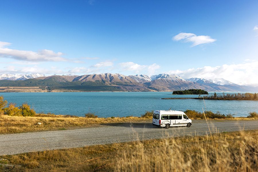 Camper van driving along the New Zealand coastline