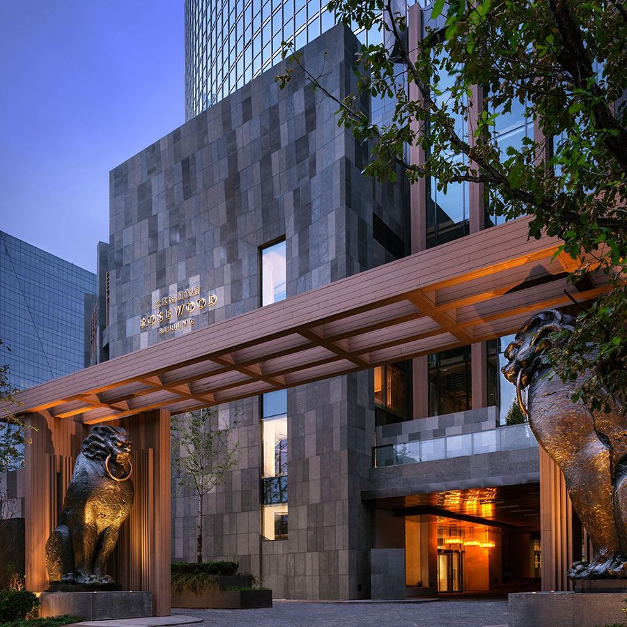 External view of the entrance of Rosewood Beijing in the evening, featuring contemporary architectural design 