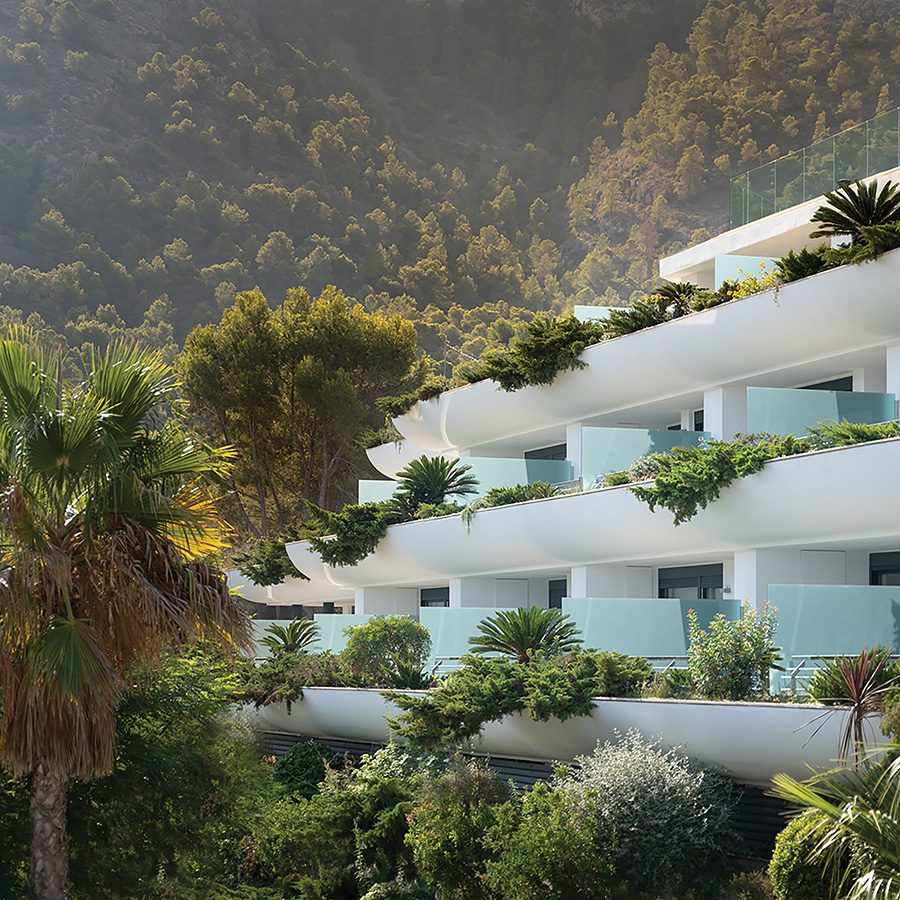 The terraced balconies of SHA Wellness with trees in the background.