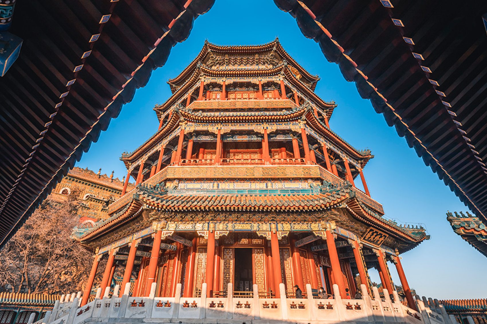A close-up shot of a tower in the Summer Palace in Beijing from under the eaves of another building. 