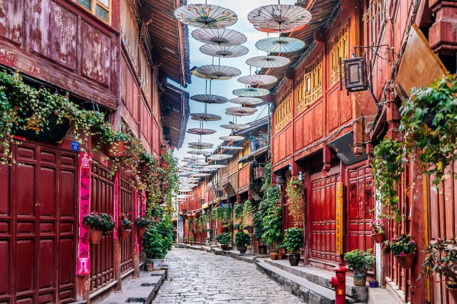Umbrellas hung up to decorate the spaces between the roofs in the old town of Lijiang.