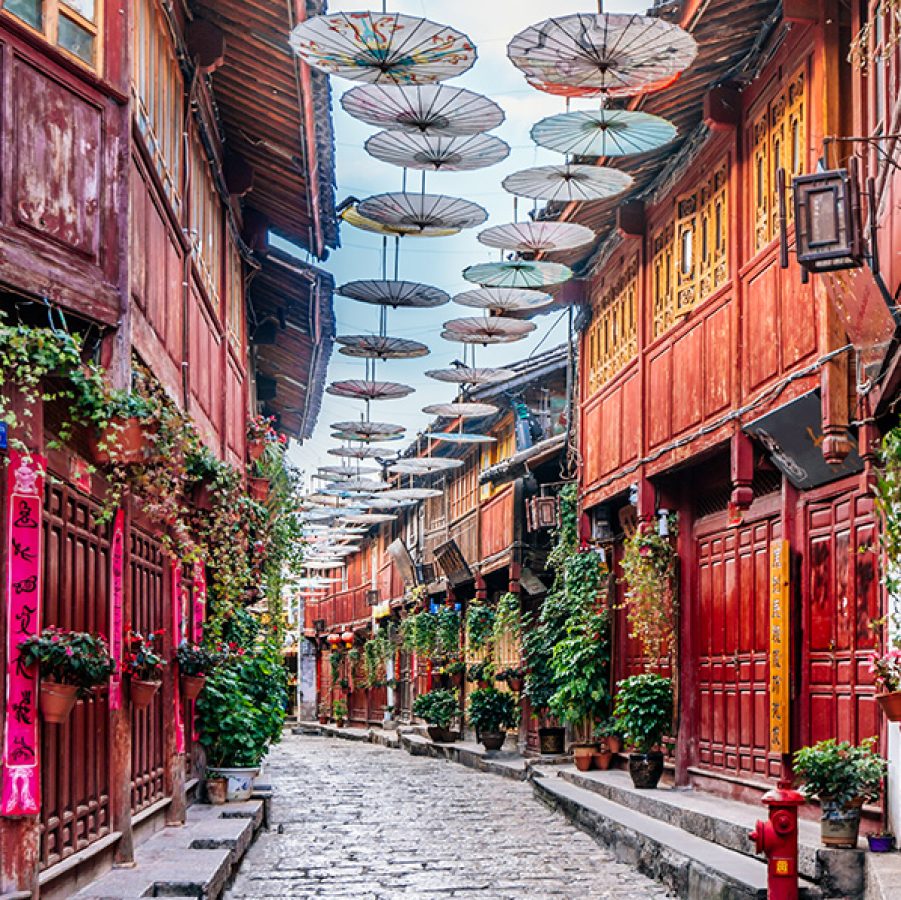  Lanterns hung on a street in Pingyao, with an ancient structure in the background. 