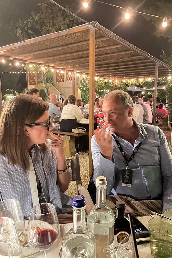 A man and a woman chatting at the dinner table. 