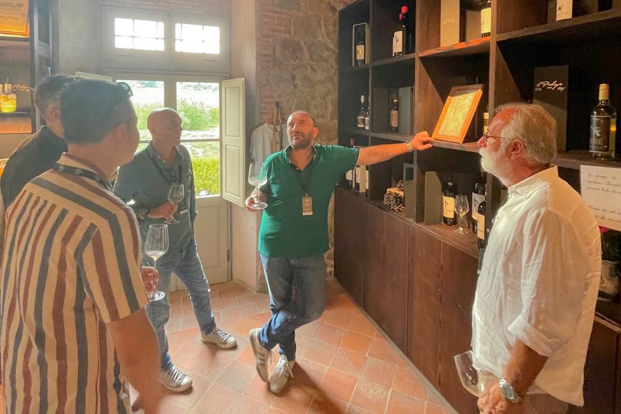 Guests tasting wines at Tenuta Il Palagio Farm Shop.