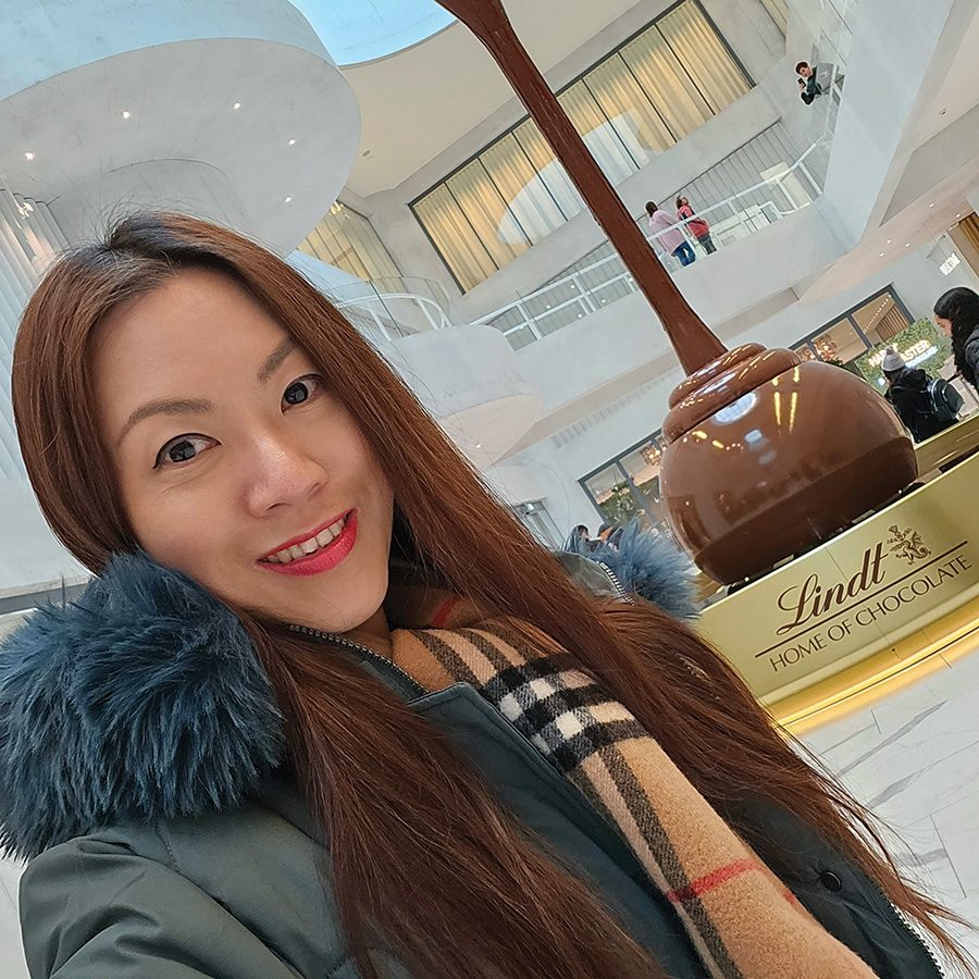 Julie Heng in front of the giant chocolate fountain at Lindt Home of Chocolate in Zurich. 