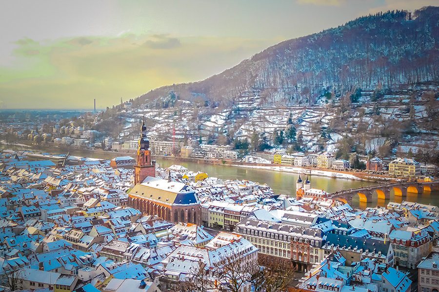 An aerial view of snow-covered rooftops on a sunny day in Heidelberg 