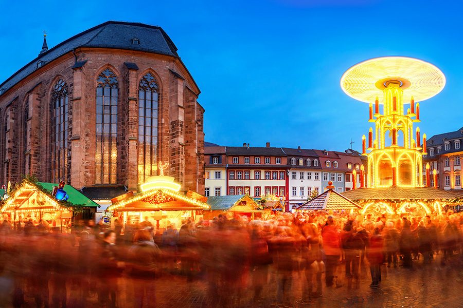 Brightly lit stalls and a traditional Christmas pyramid at Heidelberg Christmas Market