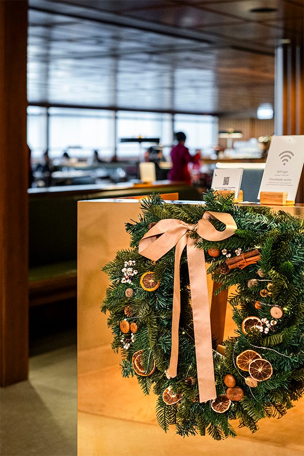 Close-up of a Christmas wreath hanging from a desk at the Cathay lounge.