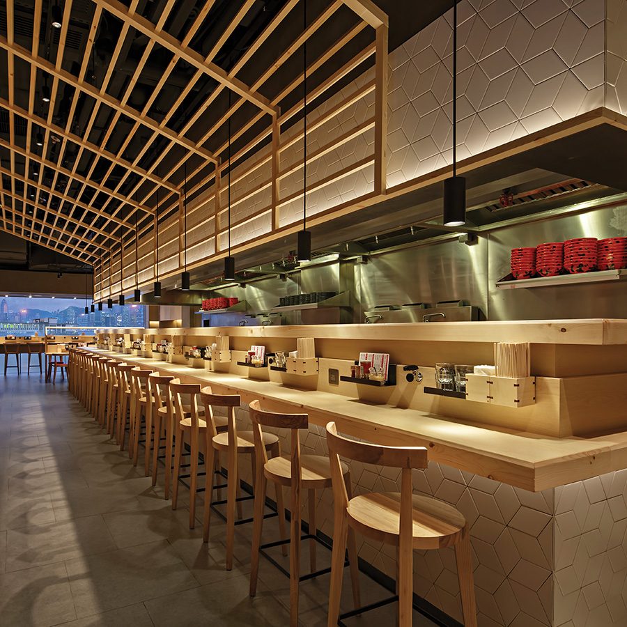 A long bar table and seats at Ebisoba Ichigen in Hong Kong.