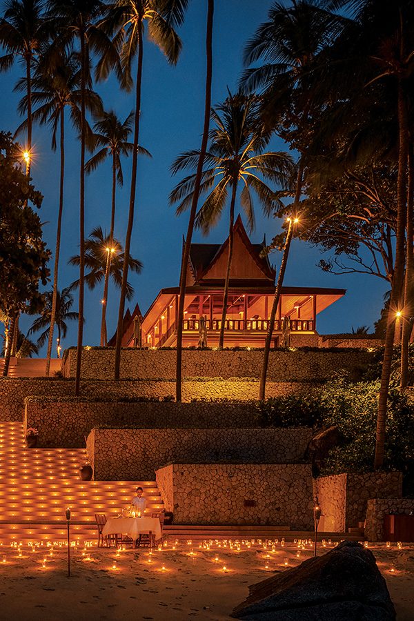 A private candlelit dinner held outside at Amanpuri Phuket