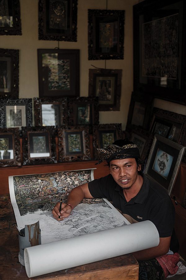 Wayan Gama of Keliki Art School drawing and painting a piece of artwork at  Capella Ubud, Bali. 