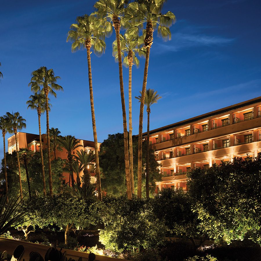 Exterior of La Mamounia, in the background behind a patch of trees