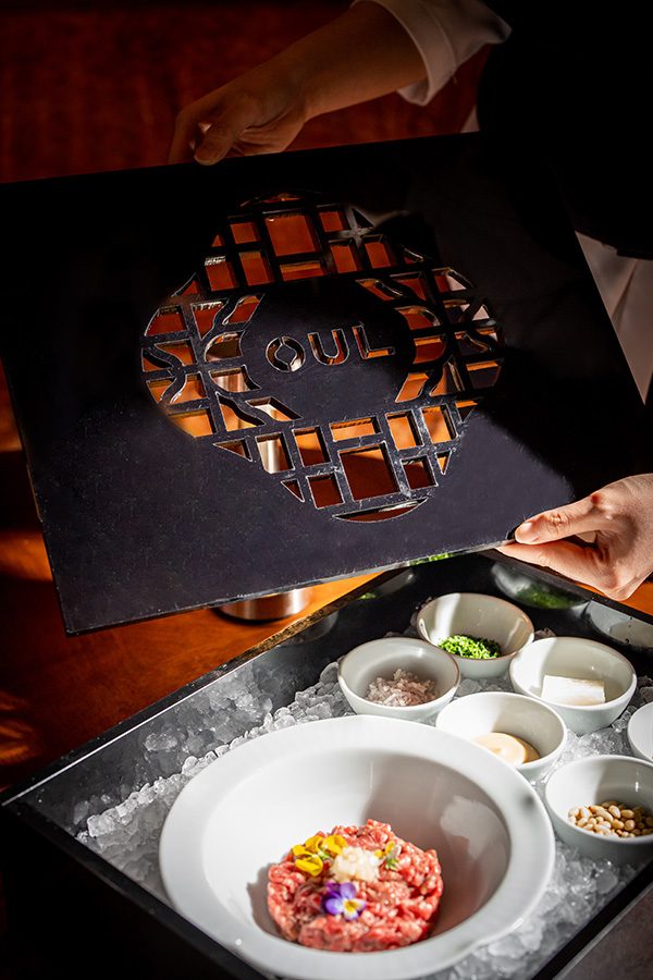 Bowls of food sitting in a tray of ice at a restaurant in Four Seasons Hotel Seoul.