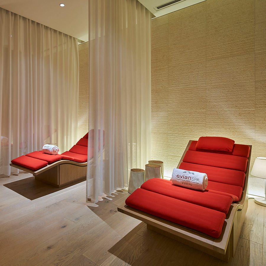 A room in Palace Hotel with red reclining chairs.