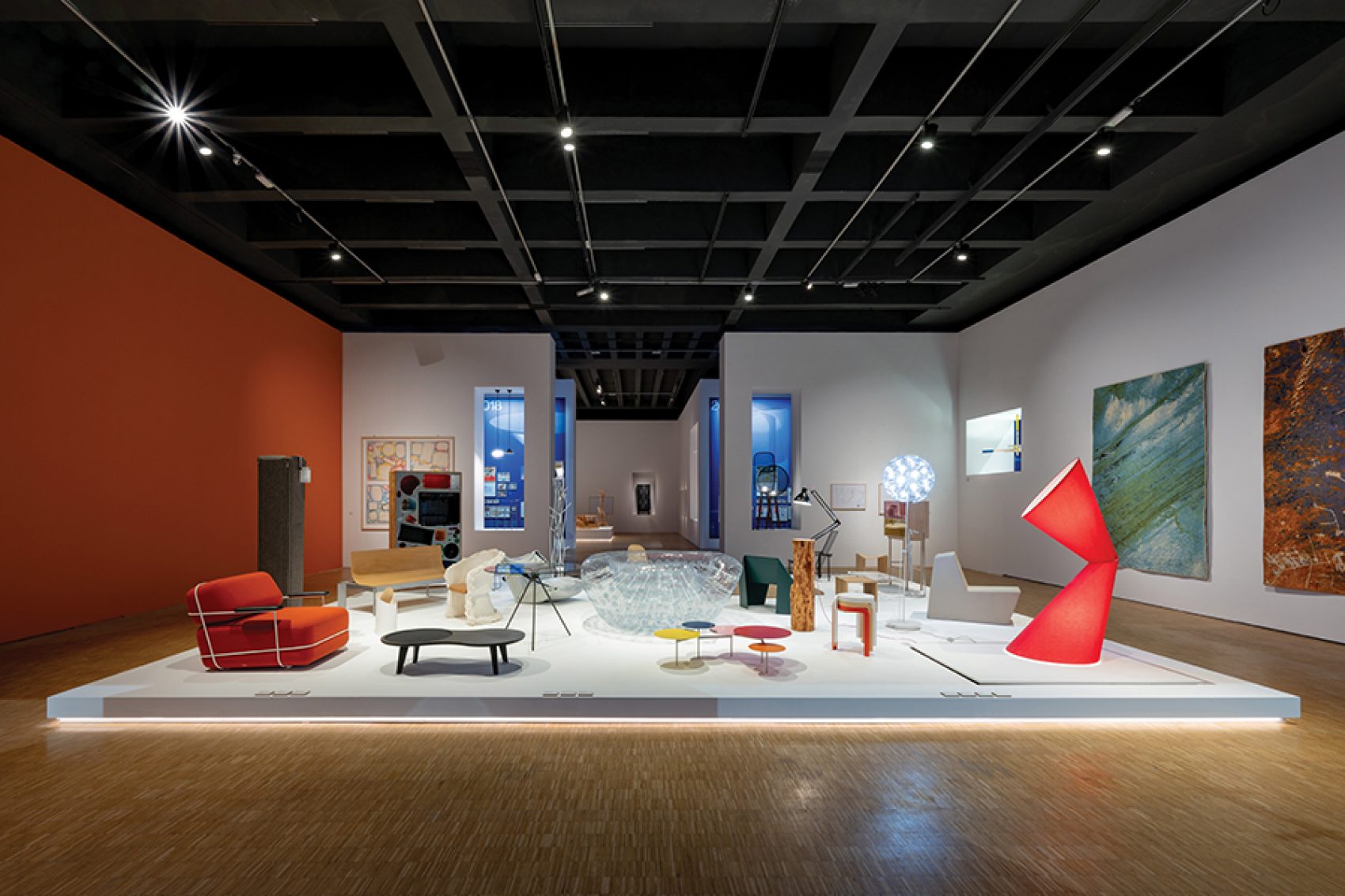 An art exhibition with a variety of colourful furniture.