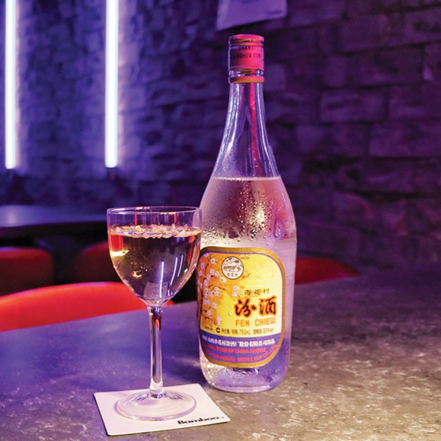 A bottle of Fen Chiew next to a glass at the neon-lit Bamboo bar.