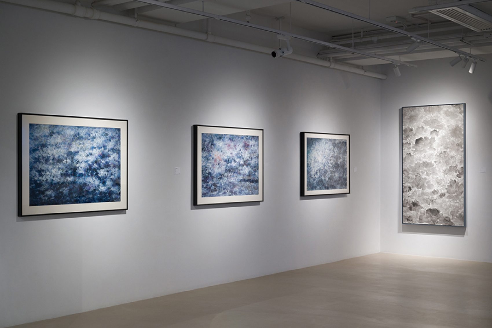 Four of Liu Guofu’s ink paintings on the wall. 