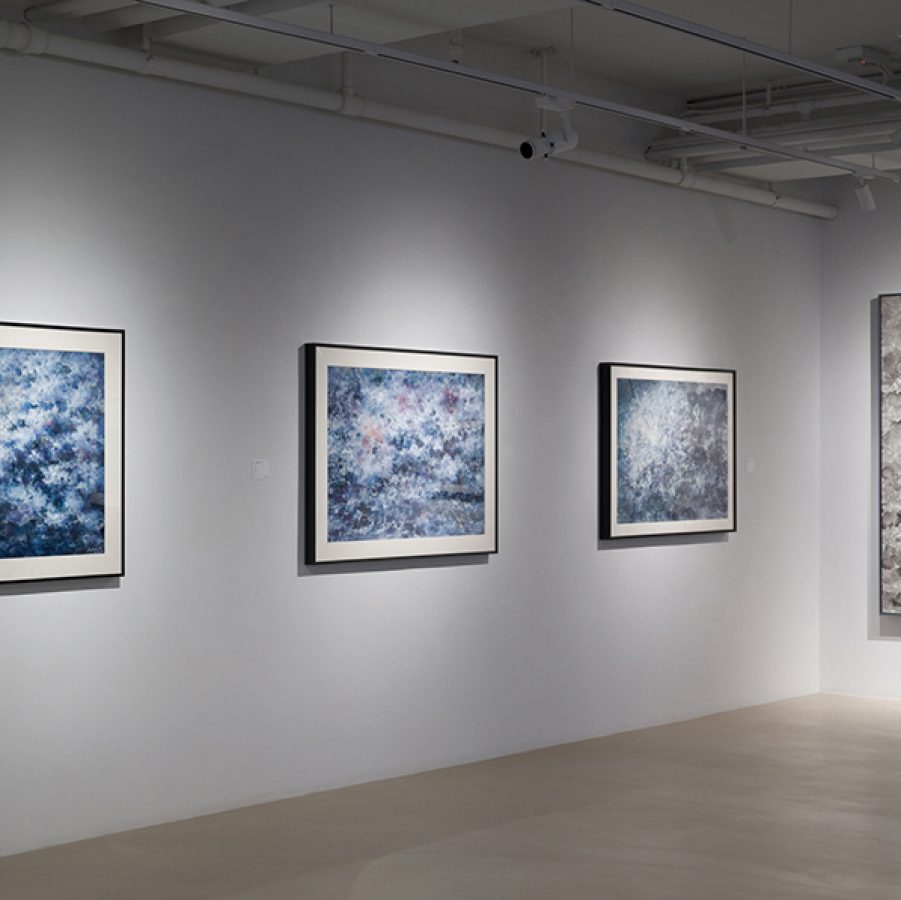 Four of Liu Guofu’s ink paintings on the wall. 
