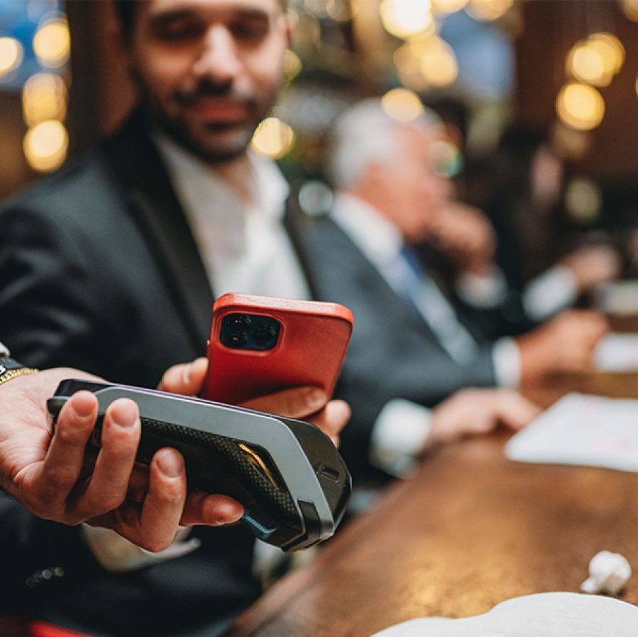 Man paying for a bill using his smartphone at a restaurant