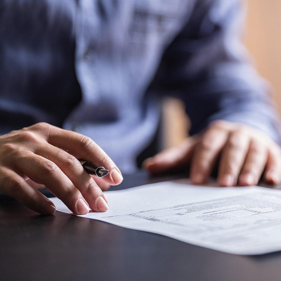  A man filling out documents.