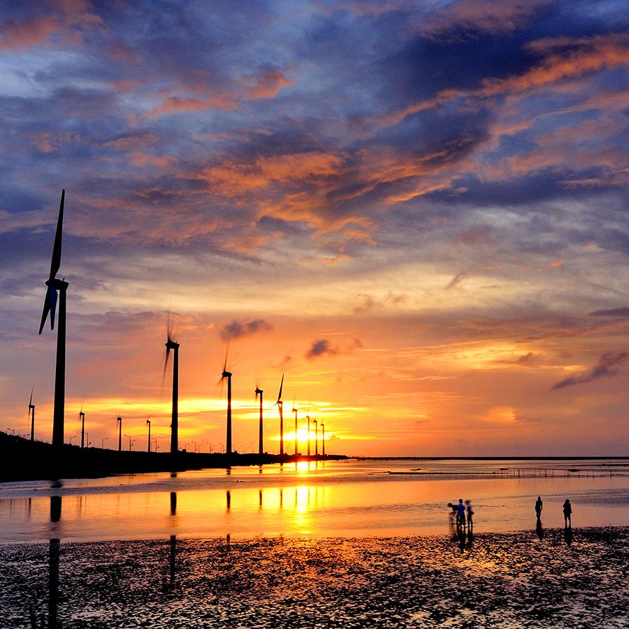 The Gaomei Wetlands, lined with wind turbines, at sunset. 