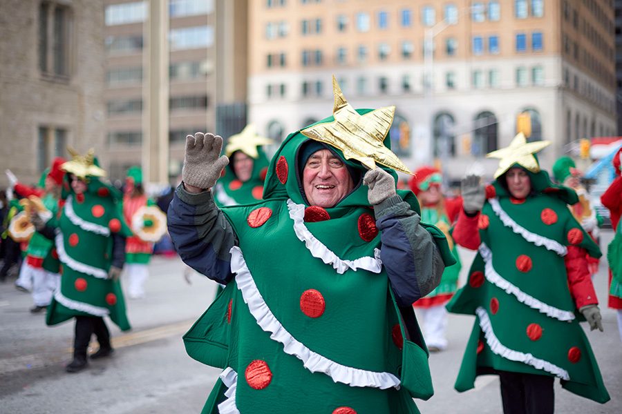 Performers dressed in Christmas tree costumes in the Toronto Santa Claus Parade. 