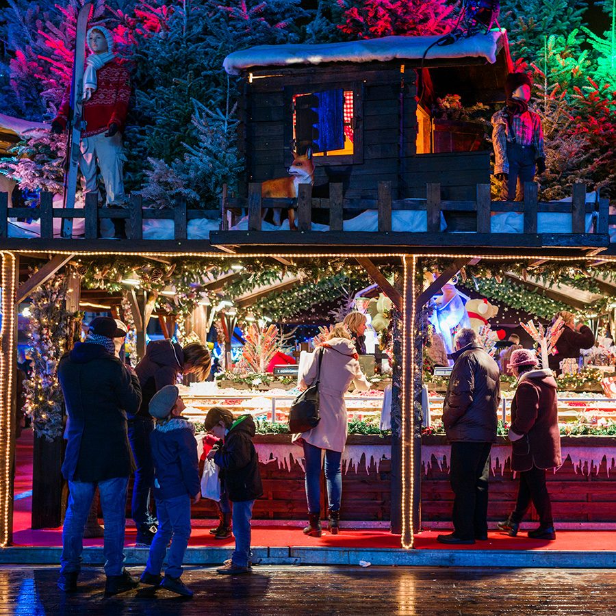People at a stall in a Christmas market in Brussels. 