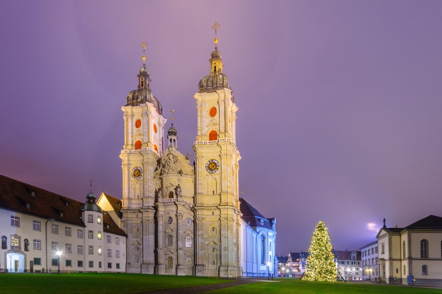 A Christmas tree next to St Gallen Cathedral in the evening.