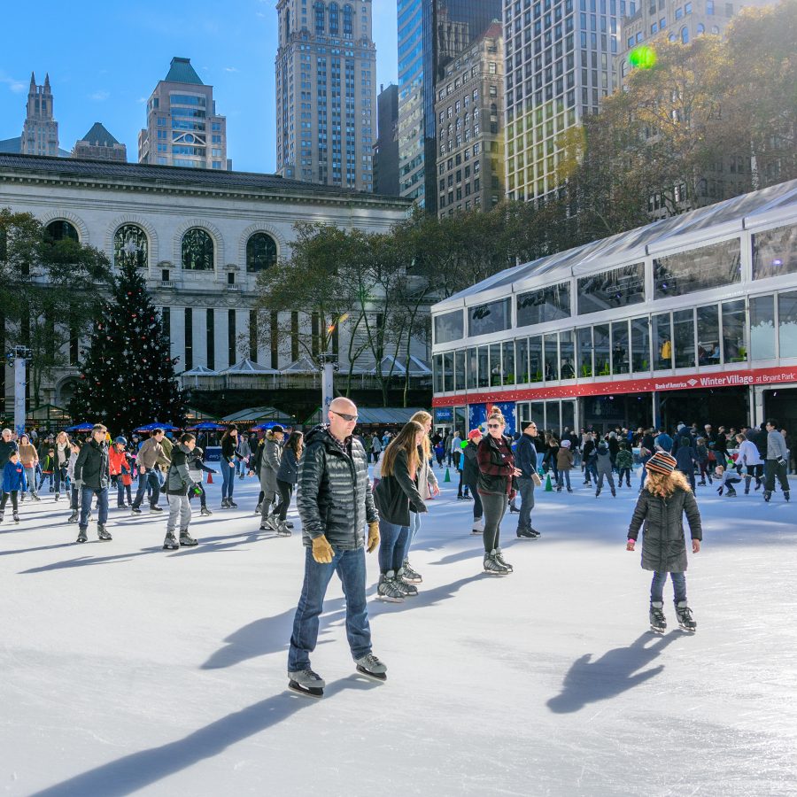 Skaters on the ice rink at Bryant Park Winter Village in New York.  